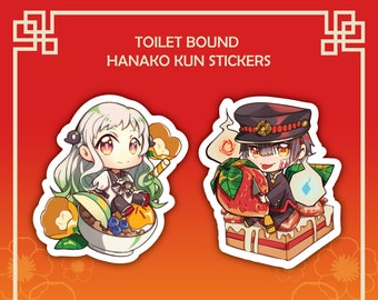 May include: Two anime character stickers, one with a girl with green hair and a white dress sitting on a bowl of fruit, and the other with a boy with red hair and a red hat sitting on a strawberry cake. The stickers are on a red background with a gold border and the text "TOILET BOUND HANAKO KUN STICKERS".