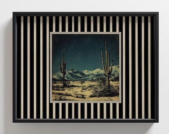 May include: A framed desert landscape print featuring a night sky, cacti, and mountains. The print is set within a black frame with a striped black and cream-colored border, creating a striking contrast. The artwork evokes a sense of the American Southwest.