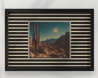 May include: A framed print featuring a desert landscape with a large cactus, mountains, and a bright sun. The frame is black with a striped pattern in black and beige.