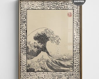 May include: Framed print of a classic Japanese woodblock print depicting a large wave. The artwork is in black and white, with a beige background. The frame is gold with a black and white dotted pattern.