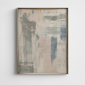 May include: Abstract art print in a gold frame. The artwork features brushstrokes in shades of gray, blue, and beige. The painting has a textured appearance, with visible brush marks and a neutral color palette.