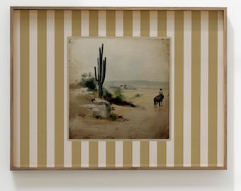 May include: A framed print of a desert landscape with a tall cactus in the foreground. The print is set against a background of beige and white vertical stripes.