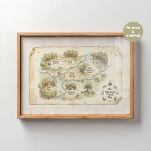 May include: A framed print of a whimsical woodland map. The map features illustrations of trees, rivers, and landmarks like Badger's Burrow and Fox's Den. The text "Our Woodland Friends Map" is visible. The frame is made of light-colored wood.