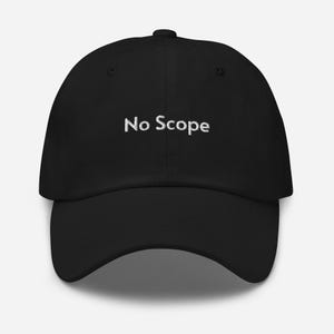 May include: Black baseball cap with the embroidered text "No Scope" in white. The cap has a curved brim and a structured fit. A classic, casual accessory.