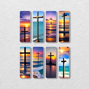 May include: Eight different bookmarks featuring a silhouette of a cross against a sunset over the ocean. The bookmarks are all the same size and shape, and they are arranged in a grid pattern.