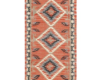 May include: Rectangular woven rug featuring a geometric diamond pattern in red, grey, black, and cream. The rug has a fringed edge and a repeating diamond design. Suitable for a living room or bedroom, it measures approximately 150cm x 90cm.