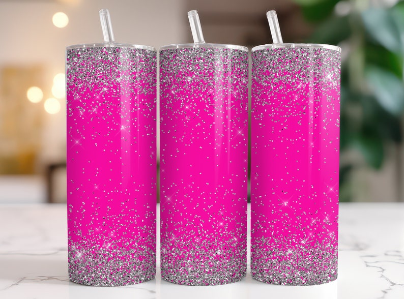 May include: Three stainless steel tumblers with pink and silver glitter designs. The tumblers have lids and straws.