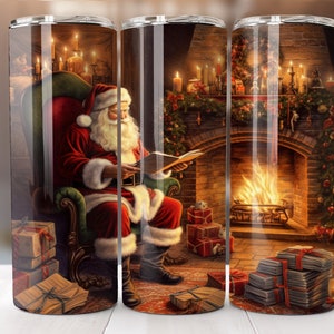 May include: A stainless steel tumbler featuring a festive Christmas scene. Santa Claus, in his red suit and hat, is seated in a chair reading a book. A fireplace with a roaring fire and wrapped gifts are also depicted. The tumbler is designed for hot or cold beverages.
