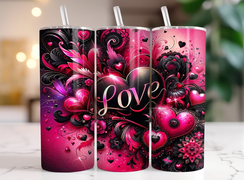 May include: Three pink and black stainless steel tumblers with a heart design and the word "LOVE" in a black font. The tumblers have a pink and black floral design with hearts and swirls.