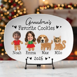 May include: A white oval ceramic serving platter featuring the black text "Grandma's Favorite Cookies" and "2026". The design includes four gingerbread-style figures with photographic faces labeled Noah, Emma, Max, and Milo, accented by black hearts.