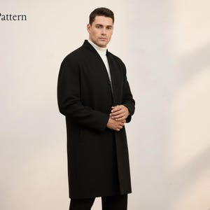 May include: A black overcoat with a mandarin collar. The coat is buttoned and worn over a white turtleneck. The brand name "Nosta Pattern" is visible in the upper left corner. The coat is knee-length.