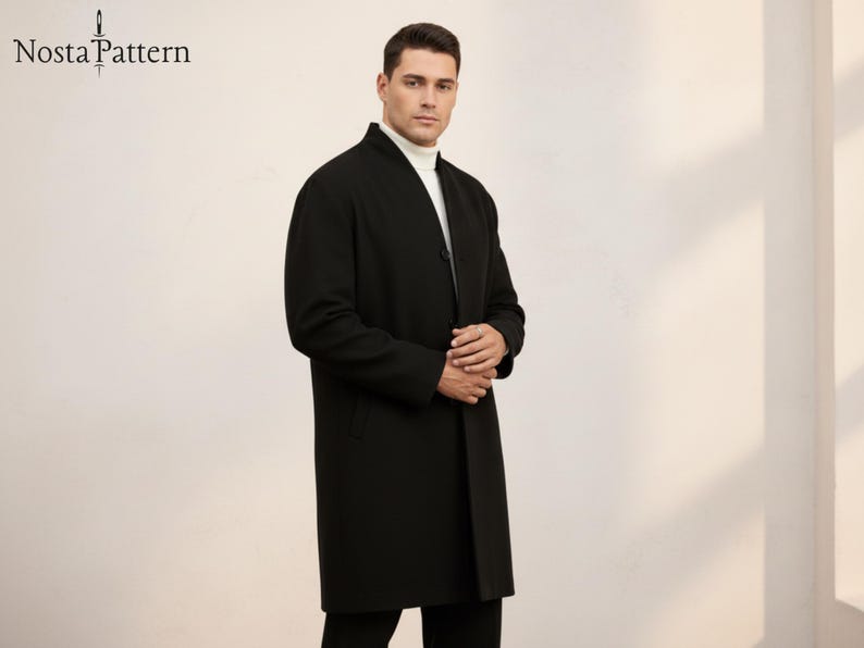 May include: A black overcoat with a mandarin collar. The coat is buttoned and worn over a white turtleneck. The brand name "Nosta Pattern" is visible in the upper left corner. The coat is knee-length.