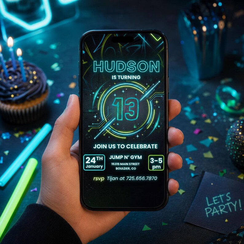 May include: A smartphone displays a birthday invitation with neon green and blue text. The invitation reads "HUDSON IS TURNING 13" and includes event details. A cupcake with lit candles and party decorations are in the background.