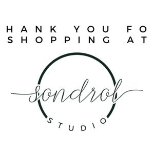May include: White background with black text that reads "THANK YOU FOR SHOPPING AT" above a circular logo. The logo features the word "sondrol" in cursive script within a dark green circle, with "STUDIO" below.