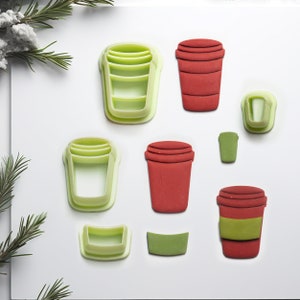 May include: A set of nine cookie cutters in the shape of coffee cups. The cutters are made of green and red plastic. There are six different sizes and shapes of coffee cups.