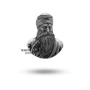 May include: Silver pendant featuring a detailed bust of a bearded man wearing a turban. The man is holding his hands in a prayer position. The pendant is a religious symbol.