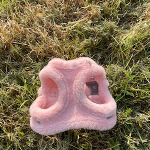 May include: Pink faux fur dog harness with the word "SKY" on the back.