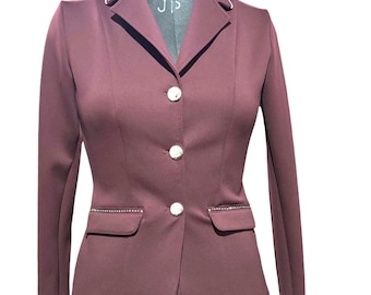 May include: A maroon riding jacket with a white collar and gold buttons. The jacket has a fitted silhouette and features a row of rhinestones on each side of the front pockets.