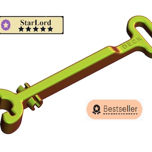 May include: A green metal key with a loop handle and the word "DECK" printed on it. The key has a unique design with a curved end and two small metal pieces attached to the shaft.