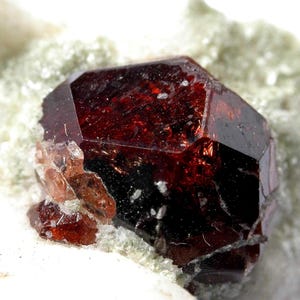 SPESSARTINE GARNET - Fine Spessartine garnet crystals attached to matrix from Pakistan.