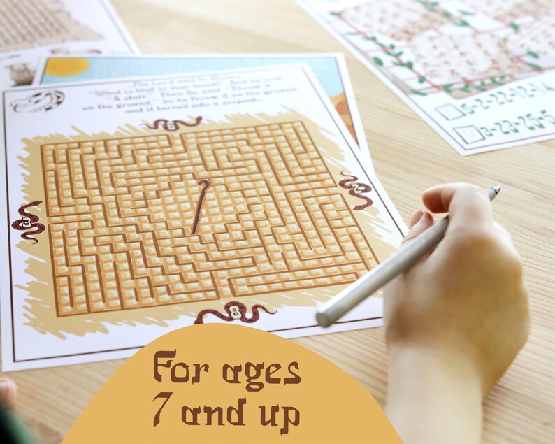 May include: A printed maze puzzle with a brown and tan color scheme. The maze is being traced with a silver pen. The text "For ages 7 and up" is displayed on the bottom of the image. Other printed sheets are in the background.