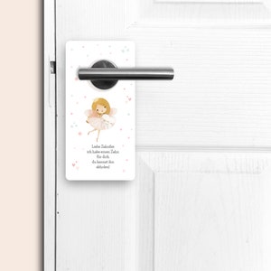 May include: A white door hanger with a pink fairy holding a tooth. The text on the hanger reads "Liebe Zahnfee, ich habe einen Zahn f&uuml;r dich, du kannst ihn abholen!"
