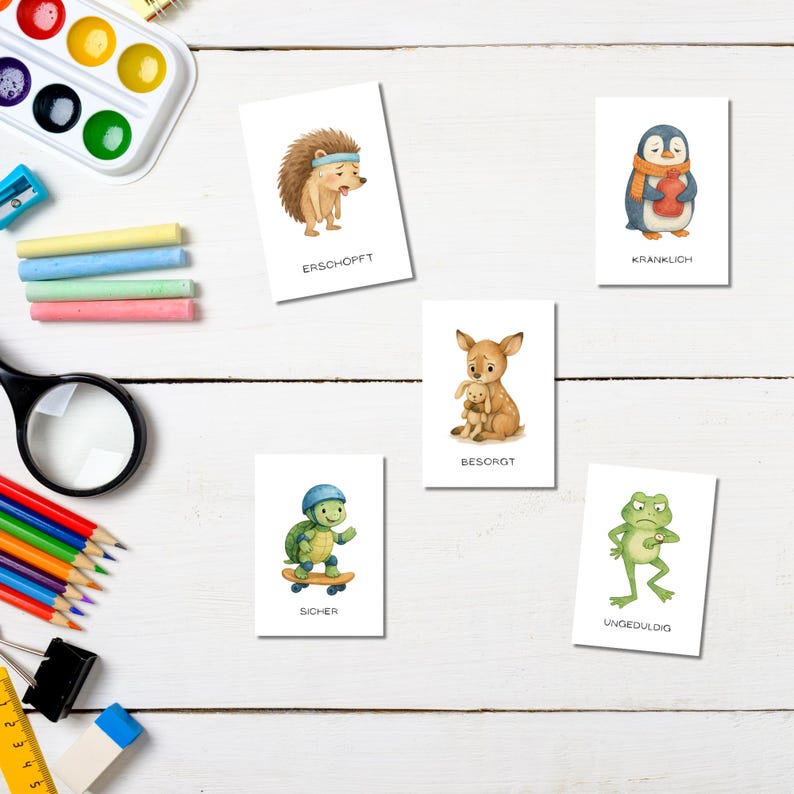 May include: Set of six illustrated cards featuring watercolor animals expressing different emotions. The cards include a hedgehog, penguin, deer, turtle, and frog. Each card has a German word describing the animal's emotion.