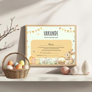 Puede incluir: Un certificado amarillo y blanco con el texto "URKUNDE OSTER-SCHNITZELJAGD" y un conejito sosteniendo una cesta de huevos. El certificado es para Max e indica que complet&oacute; con &eacute;xito la b&uacute;squeda de huevos de Pascua. La fecha es 20.04.2025.
