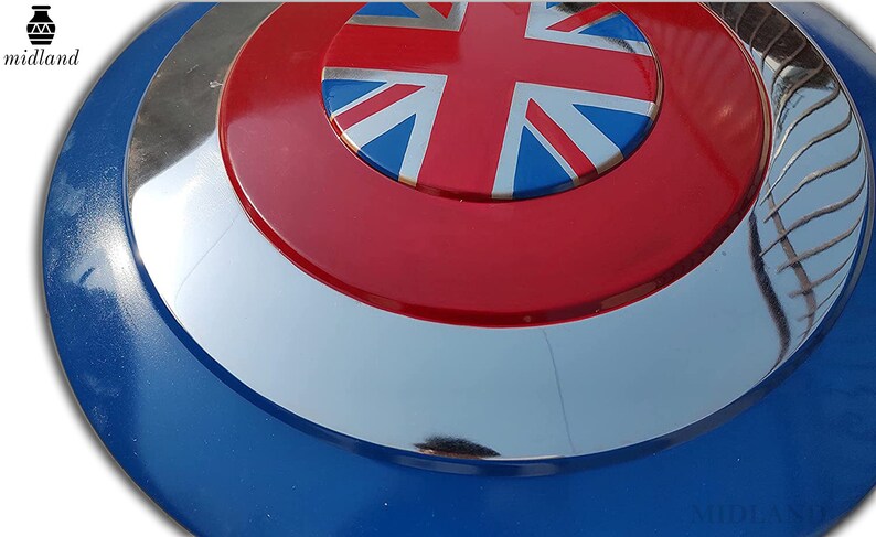 May include: A circular shield in blue, silver, and red. The centre displays a Union Jack on a red background. The shield has a reflective, metallic finish and a blue outer edge.