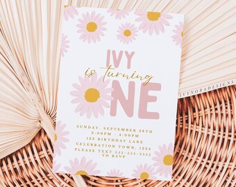 May include: A pink and gold birthday invitation with a floral design. The invitation says "Ivy is turning one" with a pink and gold "one" in large letters. The invitation includes the date, time, and location of the party.