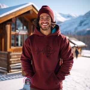 May include: A maroon hoodie with a black graphic of a bow and arrow inside a heartbeat. The hoodie has a drawstring hood and a kangaroo pocket.