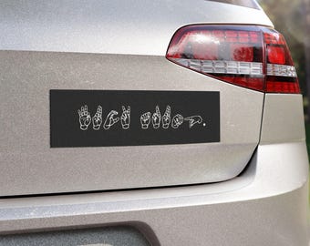 May include: Black bumper sticker with white sign language symbols spelling "I love you".