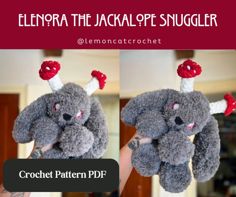 May include: A grey plush jackalope toy with red and white mushroom accents. The toy has red embroidered eyes and a black nose. The text "ELENORA THE JACKALOPE SNUGGLER" and "@lemoncatcrochet" are displayed above the toy. The text "Crochet Pattern PDF" is displayed below the toy.