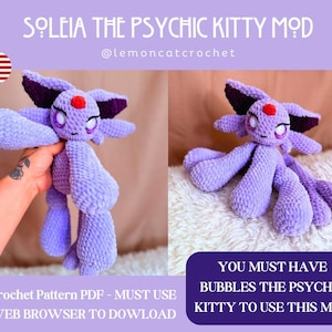 May include: A lavender crochet plush toy, featuring a character with large ears, a red gem, and multiple limbs. The image includes the text "SOLEIA THE PSYCHIC KITTY MOD" and "@lemoncatcrochet". Additional text states "Crochet Pattern PDF - MUST USE WEB BROWSER TO DOWLOAD" and "YOU MUST HAVE BUBBLES THE PSYCHIC KITTY TO USE THIS MOD."