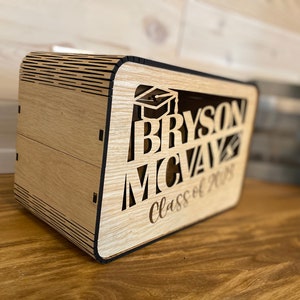 May include: A wooden box with a graduation cap design and the text "BRYSON MCVAy Class of 2023".