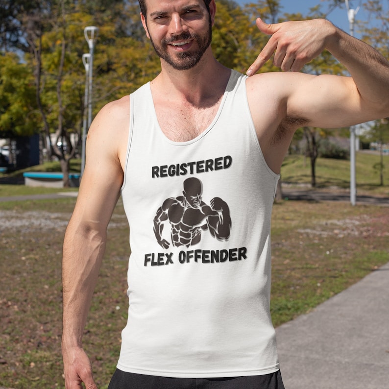 May include: White tank top with the text "REGISTERED FLEX OFFENDER" in black, along with a graphic of a muscular figure. The tank top is worn by a person outdoors.