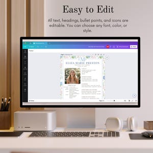 Puede incluir: Un monitor de computadora muestra una plantilla de curr&iacute;culum vitae con el texto "Easy to Edit" y el nombre "ELIZA MARIE PRESTON". El curr&iacute;culum tiene un borde floral y una foto. El monitor est&aacute; sobre un escritorio con teclado, rat&oacute;n, auriculares y una peque&ntilde;a caja de madera.