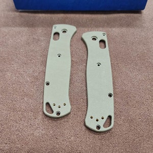 May include: Two green Benchmade knife scales with gold screws. The scales are made of G10 and are designed to fit a Benchmade knife.