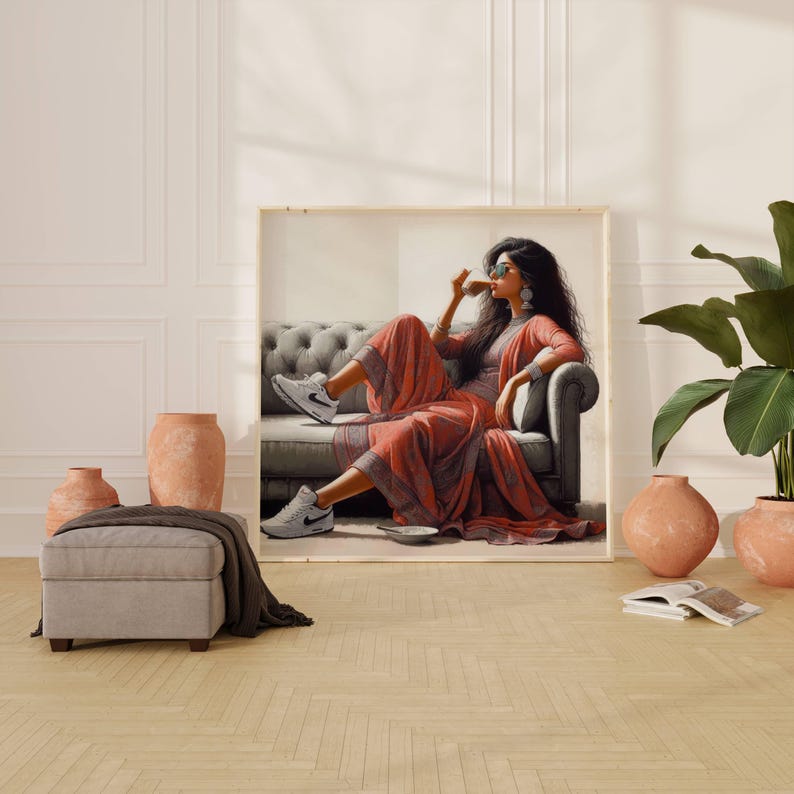 May include: A framed artwork depicts a person in a red and gray outfit, seated on a gray sofa, wearing white sneakers. The room features terracotta pots, a gray ottoman, and a large green plant. The artwork is displayed in a room with light-colored walls and a wooden floor.