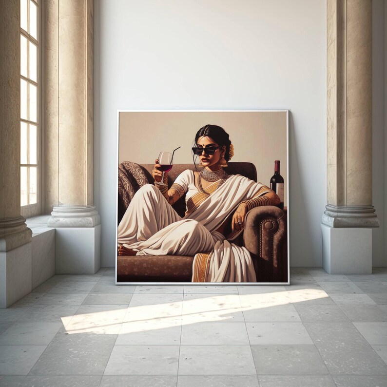 May include: A framed artwork depicts a person in a white sari, sunglasses, and jewelry, seated on a brown sofa, holding a glass of red wine. A wine bottle is visible. The artwork is displayed in a room with columns and a window.
