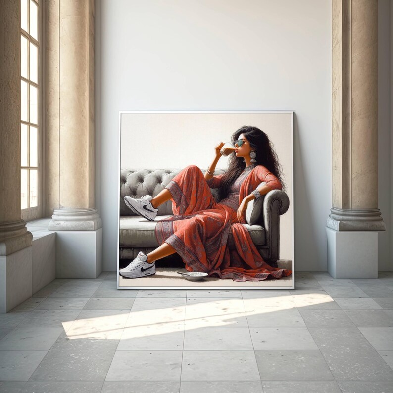 May include: A framed artwork depicts a person seated on a gray sofa, wearing a coral-colored outfit and white sneakers. The person is holding a cup, wearing sunglasses, and has long, dark hair. The artwork is displayed in a room with columns and a window.