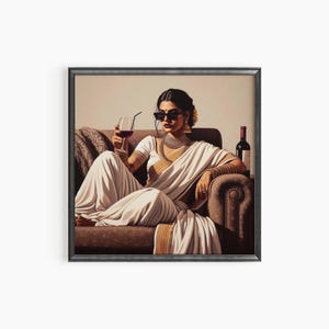 May include: A framed art print depicts a person in a white sari, sunglasses, and jewelry, holding a glass of red wine. The person is seated on a brown sofa with a bottle of wine nearby. The artwork has a vintage aesthetic.