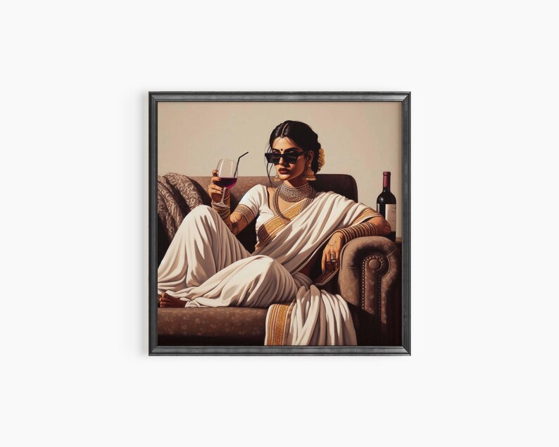 May include: A framed art print depicts a person in a white sari, sunglasses, and jewelry, holding a glass of red wine. The person is seated on a brown sofa with a bottle of wine nearby. The artwork has a vintage aesthetic.