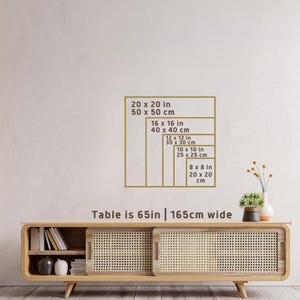 May include: A display of framed rectangular sizes in inches and centimetres, including 20x20 in (50x50 cm), 16x16 in (40x40 cm), 12x12 in (30x30 cm), 10x10 in (25x25 cm), and 8x8 in (20x20 cm). The table is 165cm wide.