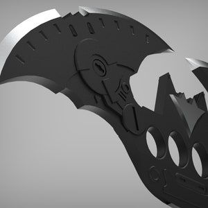 May include: A black metal batarang with a detailed design, featuring a sharp blade and a series of holes. The batarang is split into two pieces, revealing a bat symbol in the center.