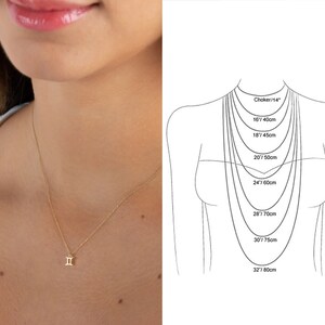 May include: A gold necklace with a Gemini zodiac sign pendant. The necklace is shown on a model wearing a white shirt. The image also includes a diagram showing different necklace lengths in inches and centimeters.