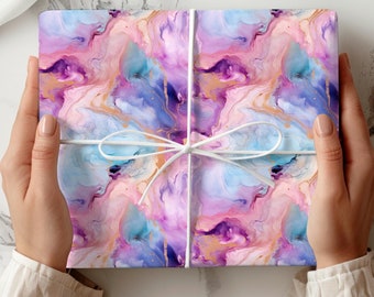 May include: A gift wrapped in colorful marble-patterned paper with a white ribbon tied in a bow.