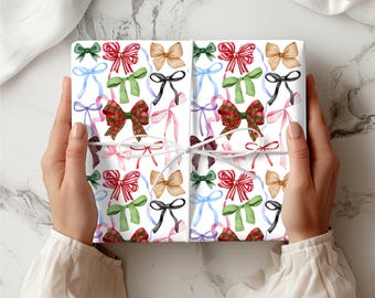 May include: White wrapping paper with a repeating pattern of colorful watercolor bows. The bows are in various shades of red, green, blue, pink, and brown.