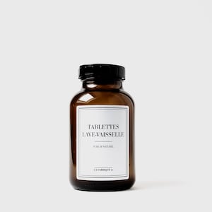 Può includere: Una bottiglia di vetro marrone con un tappo nero e un'etichetta bianca che recita "TABLETTES LAVE-VAISSELLE PURE & NATUREL LA FABRIQUE 31".