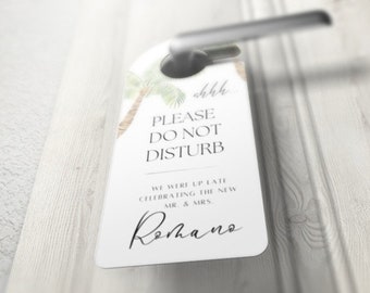 May include: White door hanger with a palm tree design and the text "ohhh... PLEASE DO NOT DISTURB WE WERE UP LATE CELEBRATING THE NEW MR. & MRS. Romano"